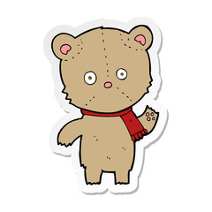 sticker of a cartoon waving teddy bear