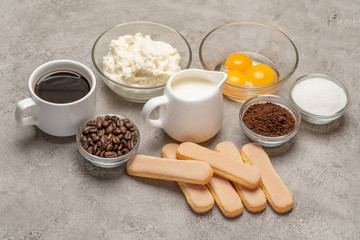 Obraz na płótnie Canvas Ingredients for cooking tiramisu Savoiardi biscuit cookies, mascarpone, cream, sugar, cocoa, coffee and egg