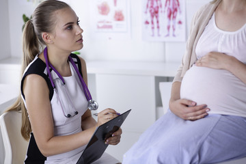 Gynecology consultation. Pregnant woman with her doctor in clinic