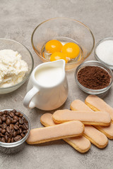 Ingredients for cooking tiramisu Savoiardi biscuit cookies, mascarpone, cream, sugar, cocoa, coffee and egg