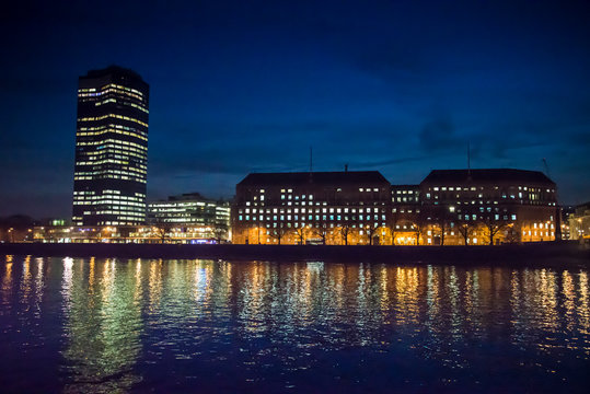 View of Millbank tower over the Thames at night, London, UK