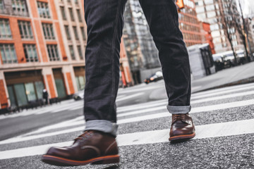 Closeup view of man legs wearing shoes crosswalk road