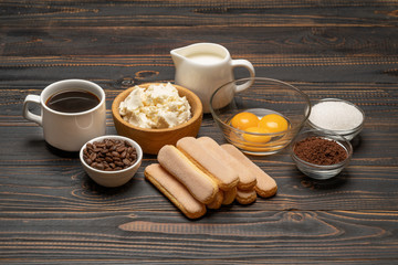 Ingredients for cooking tiramisu Savoiardi biscuit cookies, mascarpone, cream, sugar, cocoa, coffee and egg