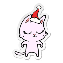 calm sticker cartoon of a cat wearing santa hat