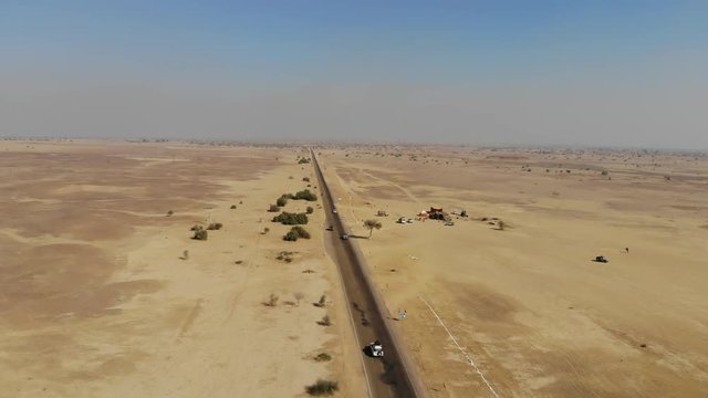 AERIAL Cars driving on a desert road in rajasthan india