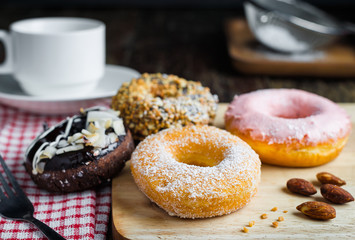 Donut and coffee cup set on wooden table.