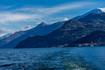 Italy, Bellagio, Lake Como, a large body of water with a mountain in the background
