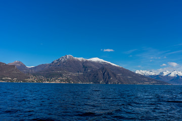 Italy, Bellagio, Lake Como with snow covered peaks background