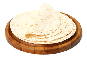 Tortilla wrap on wooden board isolated on white background