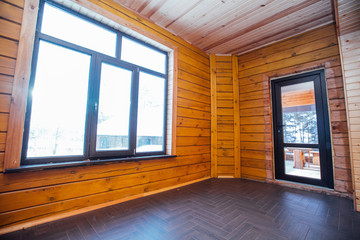 Spacious wooden room with large windows