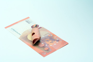 on the euro banknote lies a sports whistle. Concept - fraud in sports