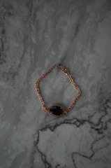 Gold rose bracelet with grey diamond