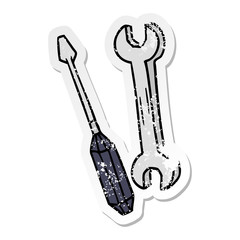 distressed sticker cartoon doodle of a spanner and a screwdriver