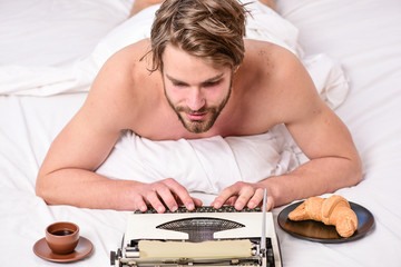 Writer handsome author used old fashioned manual typewriter. Man writer lay bed with breakfast...