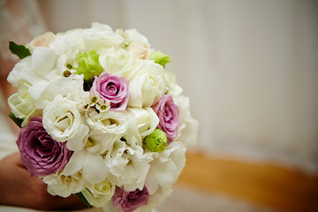 Bride holding flower bouquet 