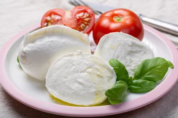 Foto op Plexiglas Soft white Italian cheese Mozzarella buffalo served with fresh tomato and green basil leaves © barmalini