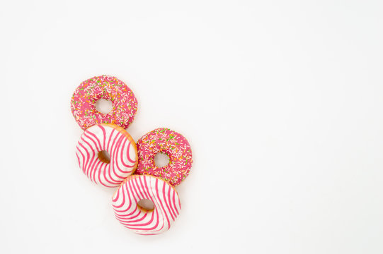 Picture of donuts  frosted, pink glazed and sprinkles donuts isolated on white background
