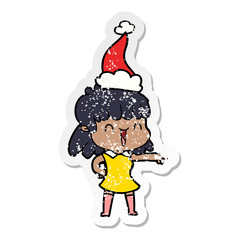 distressed sticker cartoon of a happy girl wearing santa hat