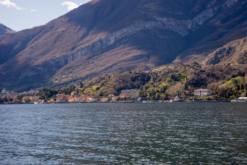Italy, Lecco, Lake Como, a large body of water with a mountain in the background