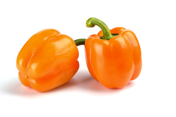Two orange bell peppers isolated on white background