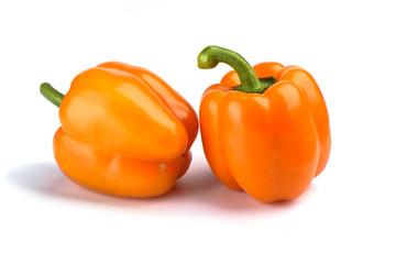Two orange bell peppers isolated on white background