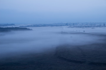 Village and forest in the fog.