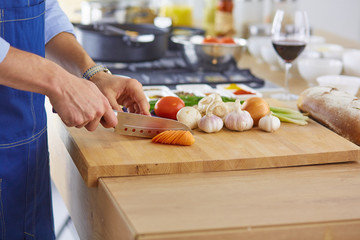 Smiling and confident chef standing in large kitchen