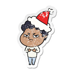 distressed sticker cartoon of a angry man wearing santa hat