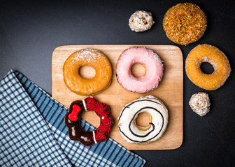 Donuts and wood on stone table.