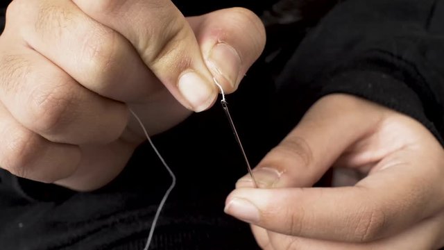 Both Hands trying to Thread a Needle