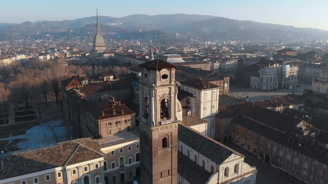 Aerian footage of the Turin Cathedral with the Mole Antonelliana on the background.