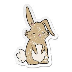 distressed sticker of a cartoon sleepy rabbit