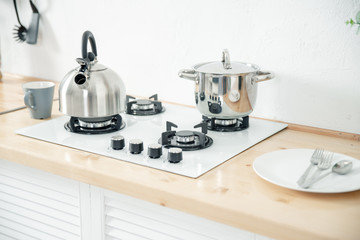 Metal kettle and saucepan on the stove