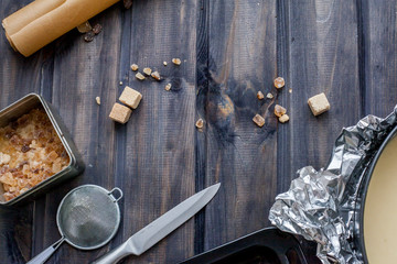 Cooking dough, cooking equipment, flour on a wooden table. Top view with copy space, mockup for menu, recipe. Baking background.