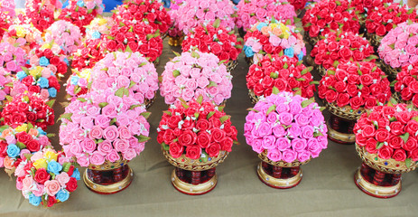 Ornamental nature colorful flowers miniature clay pink or red roses in vase background