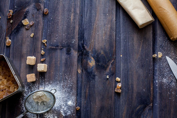 Cooking dough, cooking equipment, flour on a wooden table. Top view with copy space, mockup for menu, recipe. Baking background.