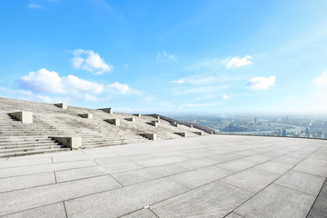 Fototapeta premium Empty square floor and modern city skyline with beautiful clouds