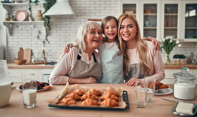 Daughter, mother and grandmother on kitchen