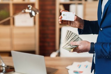 Businessman with money and banking card.