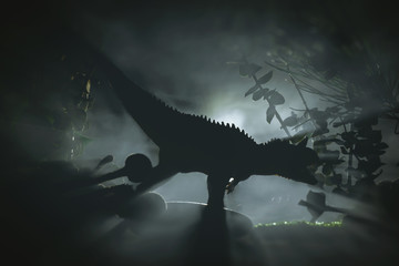 Tyrannosaurus dinosaur is hunting in a night jungle, concept of jurassic period. © Dmitriy