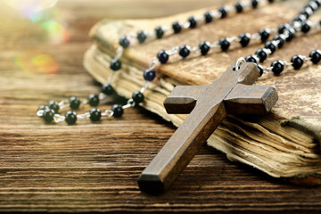 Very old holy bible and wooden cross