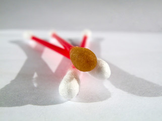 three Cotton Swab with wool fibers closeup