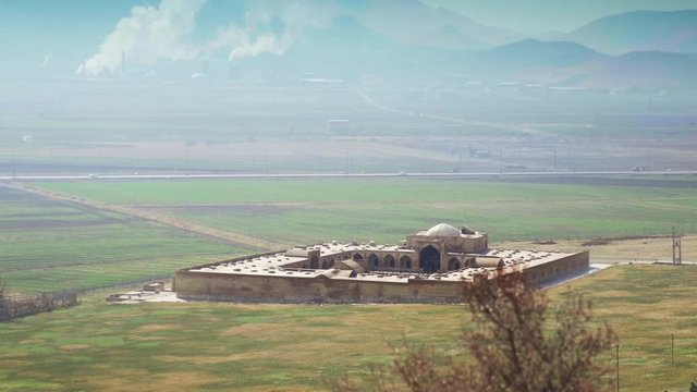 Establishing shot, Bisotun Shah Caravanserai in Iran on sunny day.
