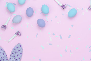 Table top view shot of decorations Happy Easter holiday background concept.Flat lay colorful eggs with cute bunny ear & confetti on modern rustic pink paper.Blank space creative design for mock up.