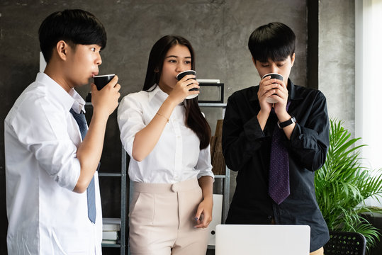 Young business partner ddrinking coffee between meeting,relax time,at office