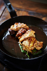 Grilled chicken on frying pan 
