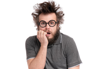 Crazy Scared Man with funny Haircut in eye Glasses, bites his nails and looks worried. Bearded guy afraid and shocked, isolated on white background. Emotions and signs concept.