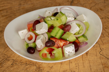 Greek salad with tomatoes, cucumbers, feta cheese, olives, fresh pepper, onion and oregano.