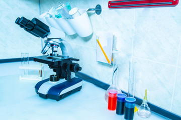 Microscope. Microscope with flasks and reagents in the laboratory. Optical instruments....