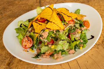 Tuna salad, iceberg lettuce, arugula, tortilla chips, corn, cherry tomatoes and balsamic dressing.